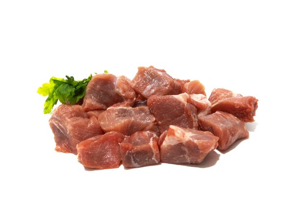 A pile of meat with a sprig of mint on the side isolated on white background