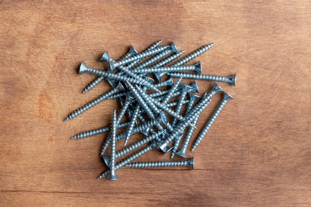 Pile of metal screws on wooden