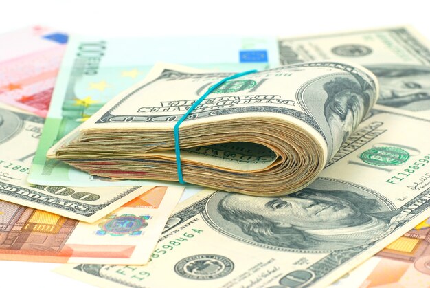 Pile of money cash of US dollars and euros for business background