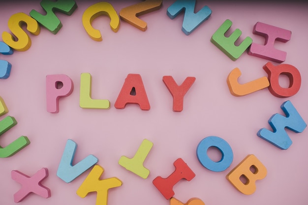 Photo the pile of multi-colored wooden alphabets