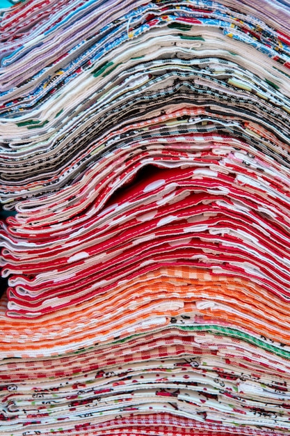 Pile of multicolor kitchen towel to sale on open air market
