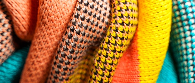 A pile of multicolored knitted fabrics