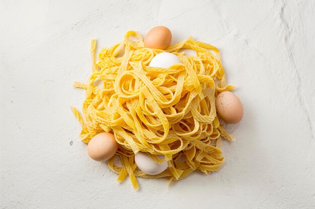 Pile of naturally colored yellow pasta with eggs Stone background