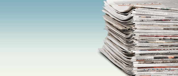 Pile of newspapers stacks on blur background