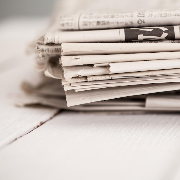 Pile of newspapers on a white table