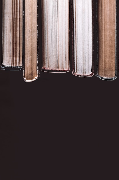 Pile of old books on a black surface