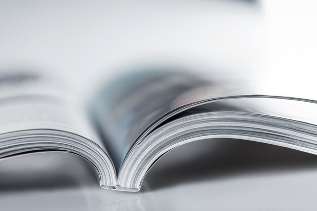 Pile of Open magazines, blue toned image