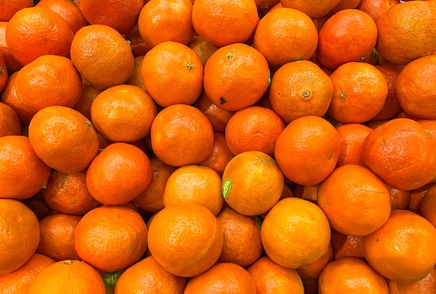 a pile of oranges with a green sticker on the top.