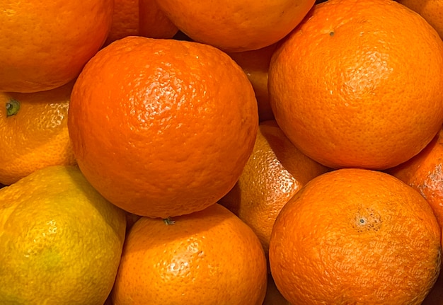 a pile of oranges with one that has a white spot on the top.