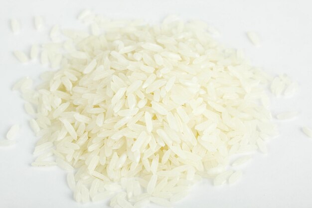 Pile of organic rice on white