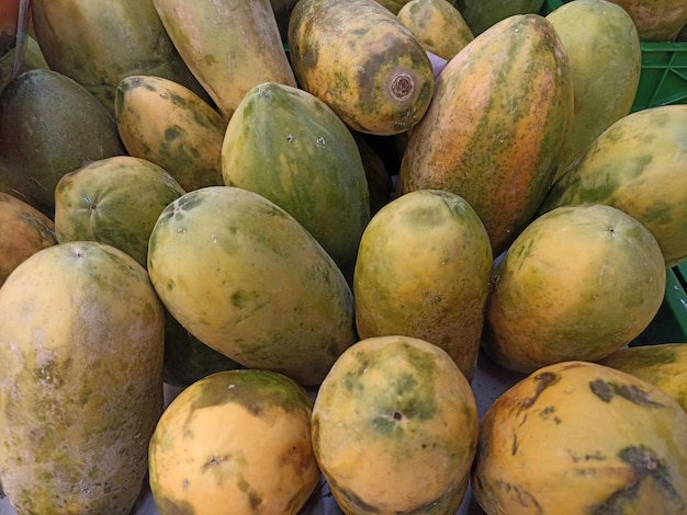 A pile of papayas on a table