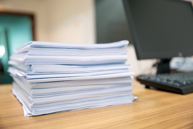 Pile of a paper on office desk stacked.