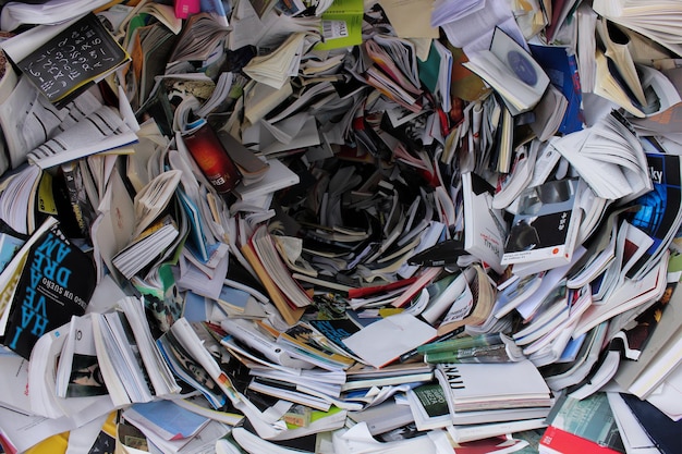 Photo a pile of papers and a spiraled hole is shown.