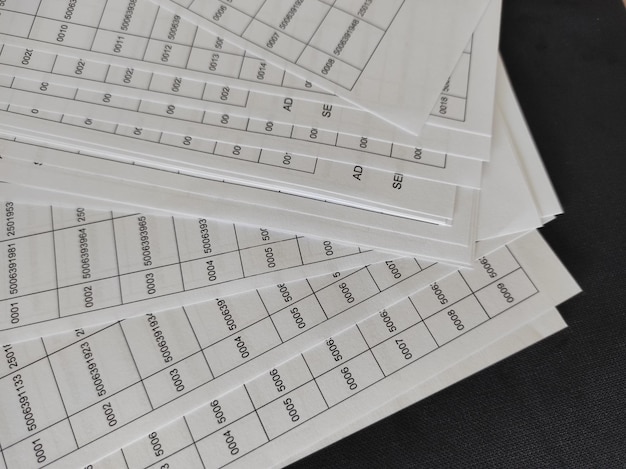 pile of papers with many numbers printed on them