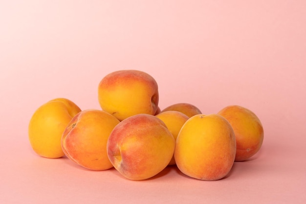 Pile of peaches on colourful background