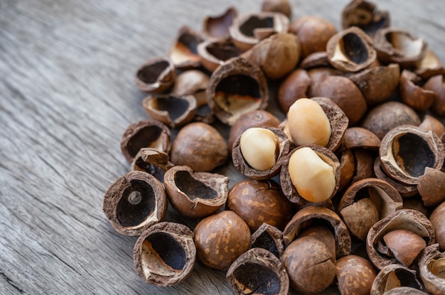 Pile of peeled organic Macadamia nuts on wooden table