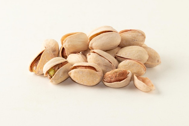 Pile of pistachios isolated on white background