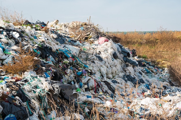 A pile of plastic rubbish food waste and other rubbish plastic\
waste dumping site