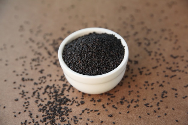 Pile of poppy seeds on wood background