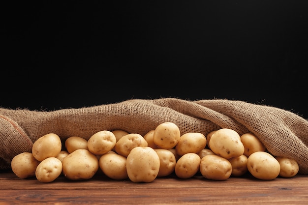 Pile of potatoes lying on wooden boards