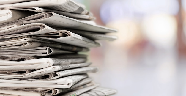 Pile of printed newspapers on background