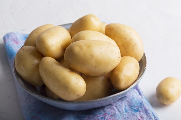 Pile of raw potatoes in the bowl  