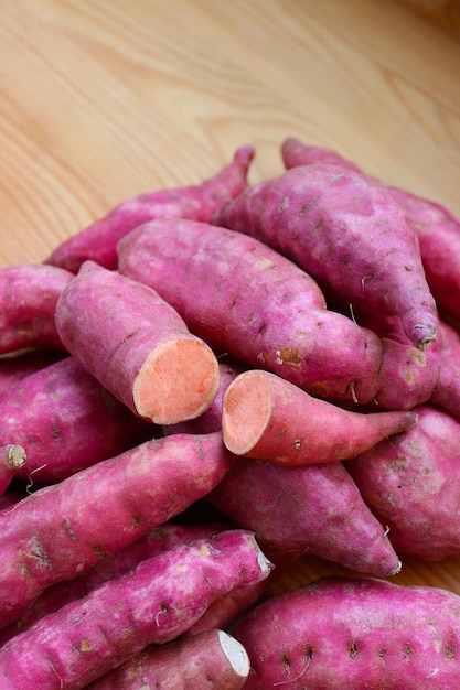 Pile of Raw Sweet Potatoes on the Wooden Table