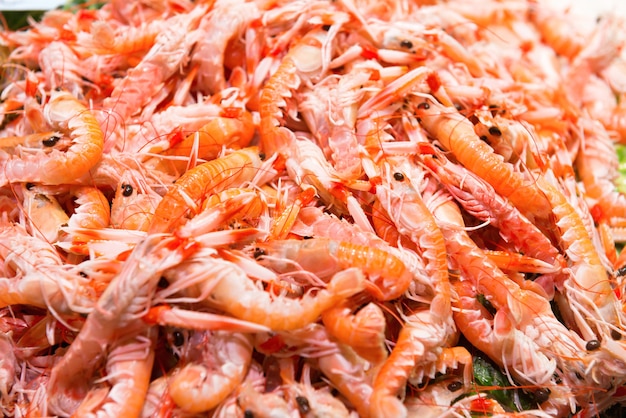 Pile of red fresh shrimps at the market. Seafood texture for background