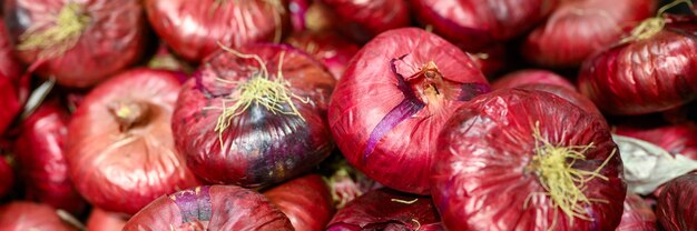 A pile of red onions background