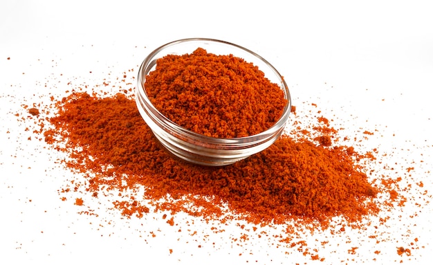 Pile of red paprika powder isolated on white background, ground hot red pepper spice