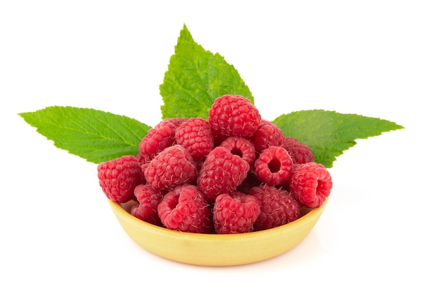 A pile of ripe red raspberries in a small wooden box