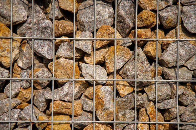 Pile of rocks sitting behind metal fence on street