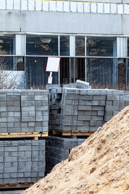 Pile of sand and paving slabs at construction site