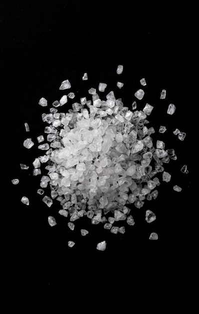 Pile of sea salt on black background