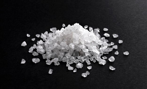 Pile of sea salt on black surface