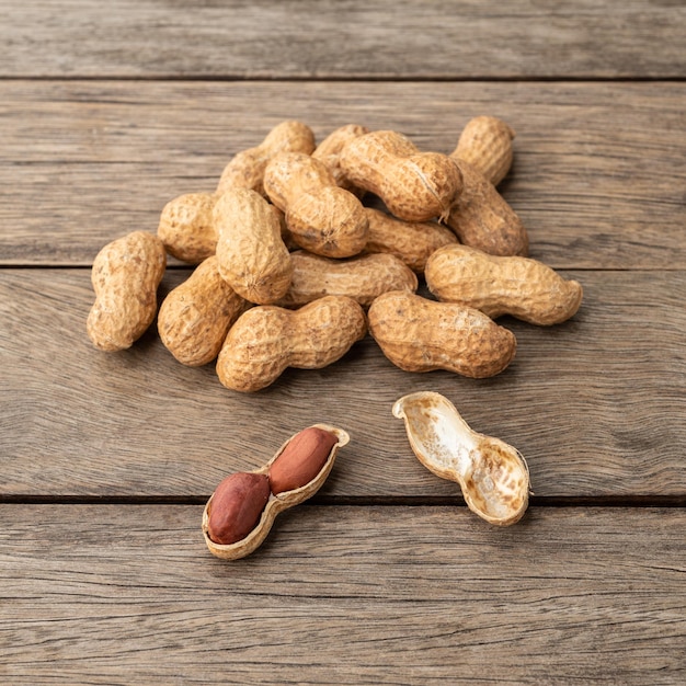 A pile of shelled peanuts over wooden table