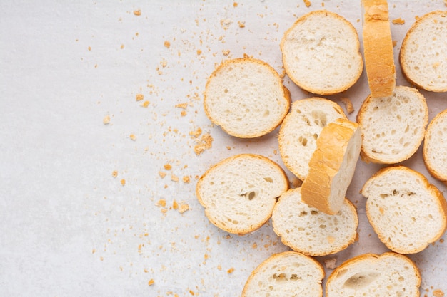 A pile sliced baguette, on the marble background.