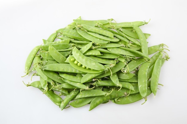 A pile of snow peas on white backgroundxA