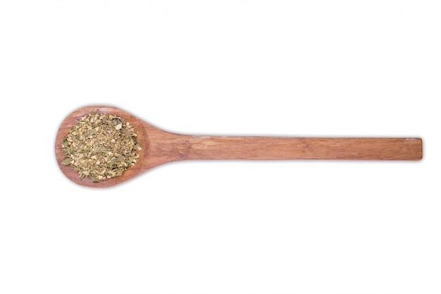 A pile of a spice mix for fish on wooden spoonIsolated on white . Spices consist salt sesame coriander mustard turmeric onion garlic spices herbs pepper