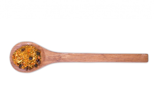 A pile of a spice mix for pilaf on wooden spoon isolated on white . Spices consist onion garlic paprika coriander barberry carrot mustard turmeric savory tomatoes cumin cumin black pepper