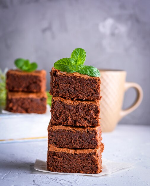 Pile of square slices of baked brownie 