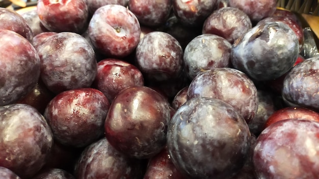 Pile of Syzygium cumini or java plum or black plum display at the market