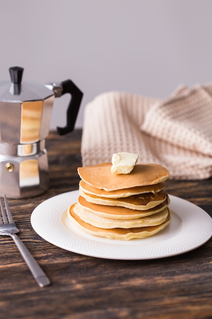 Pile of tasty pancakes with butter. Breakfast concept.