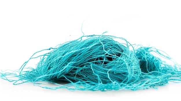 Pile of Turquoise Threads on White Background