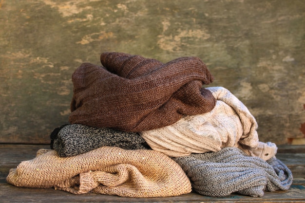 Pile of warm clothes on wooden floor