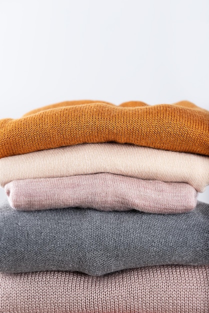 A pile of warm knitwear to keep you warm in winter economic crisis saving money fast fashion free