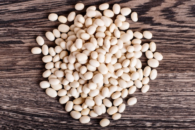 Pile of white beans isolated on a gray wooden background