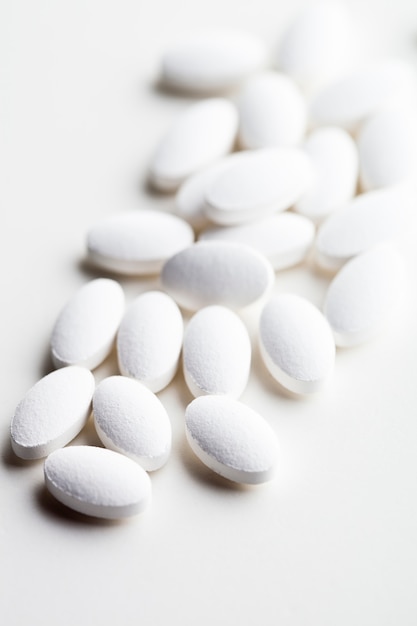Pile of white drug pills laying
