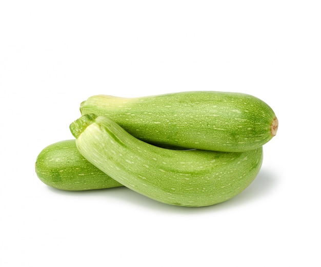 Pile of whole green zucchini isolated on a white background