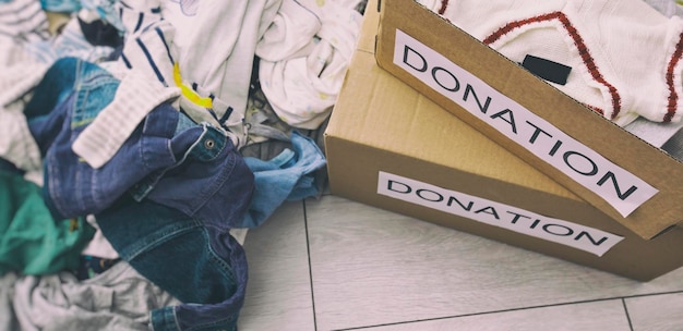 Photo the pile with different kids clothes ready for sorting for donations